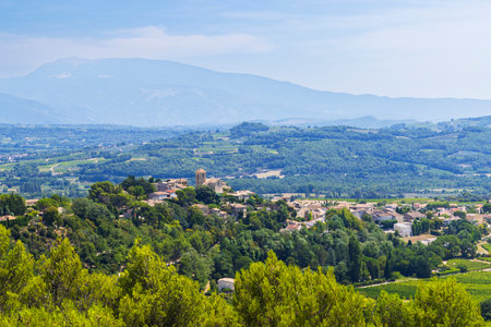 Panoramic view of Vinsobres village in the Drome department, Auvergne Rhone Alpes region, France, with Mont Ventoux in the backgroundの写真素材