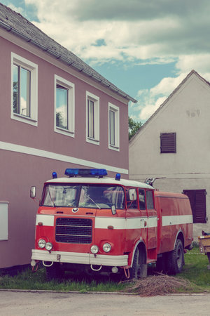 Vintage fire engine standing by a fire station in Pisecne, Czechia, ready for actionの写真素材