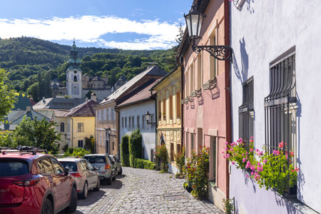 Cobblestone street with colorful houses leading to the Old Castle in Banska Stiavnica, Slovakia, a...