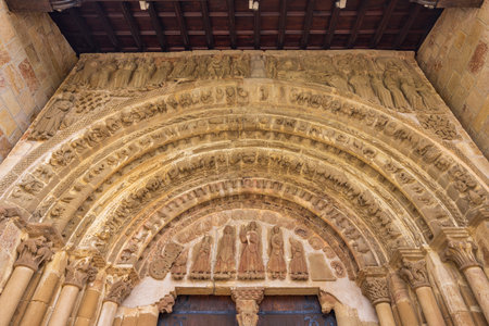 Detailed view of the richly decorated archivolts and tympanum showcasing biblical scenes and figuresの写真素材