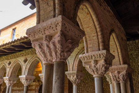 Sculpted capitals and romanesque arches in the cloister of Moissac Abbey, Occitanie, a unesco world heritage siteの写真素材