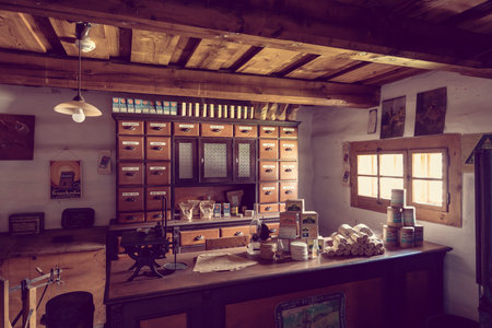 Vintage grocery store interior with wooden counter, shelves, drawers, and various products, showcasing traditional Slovakian commerce in Pribylinaの写真素材