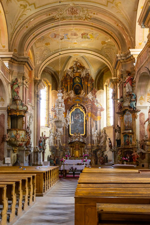 The rich baroque interior of the Church of Saint Peter and Paul in Ustek, Czechia, showcases intricate details and a serene atmosphereの写真素材