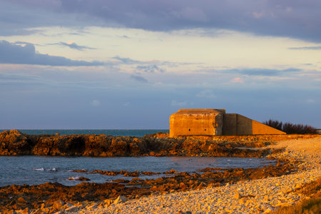 Old german bunker standing on the beach of Normandy at sunset, Manche, Franceの写真素材