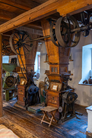 Antique wooden and metal machinery for grinding grain operating in the mill of Heimschuh, Styria, Austriaの写真素材