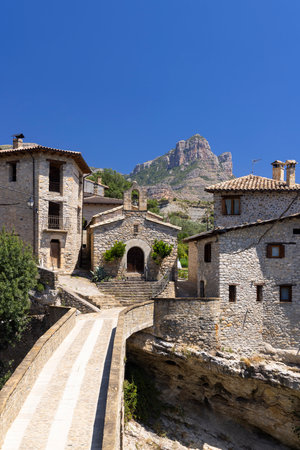 Roda de Isabena, Huesca, Spain, bridge leading to ancient stone houses and church with Pena...