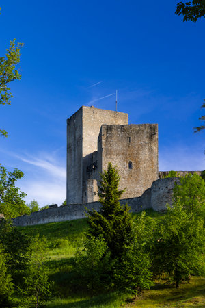 Stone castle tower against a vibrant blue sky in Czechiaの写真素材