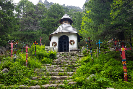Charming Chapel Surrounded by Colorful Wooden Crosses in Vysoke Tatryの写真素材