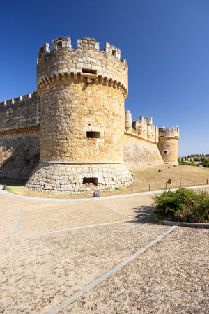 Historic stone castle under a clear blue sky in Leon, Spainの写真素材