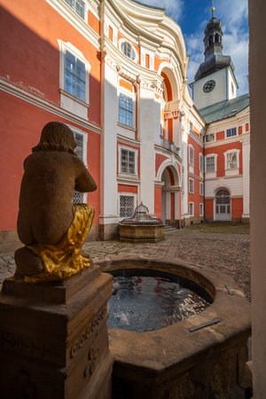 Serene courtyard with a fountain and historic architectureの写真素材