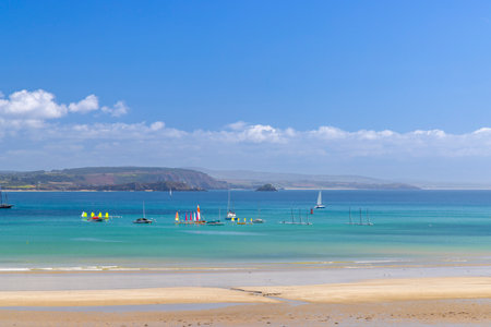 Sailboats and colorful windsurfers enjoy the serene waters of Crozon, Brittanyの写真素材