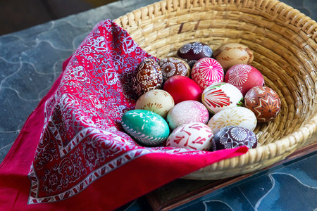 Colorful Easter eggs displayed in a basket with a red clothの写真素材