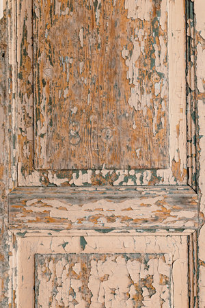 Rustic door showcasing aged, peeling paint and textured woodの写真素材