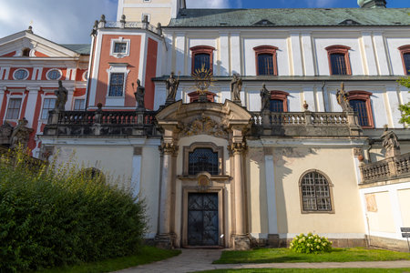 Broumov Monastery entrance showcasing intricate architectural details, statues, and a grand facade in Czechiaの写真素材