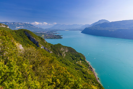 Breathtaking panoramic view of the turquoise waters of Lake Bourget, nestled amidst the verdant mountains of Savoie, near Aix les Bainsの写真素材
