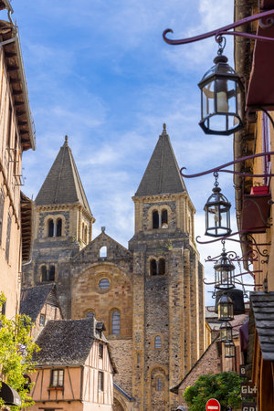 The imposing Sainte Foy Abbey dominates the skyline of Conques en Rouergue, a charming village nestled in the heart of Aveyron, Franceの写真素材
