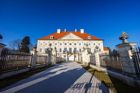Dornava Mansion, a stunning baroque palace in Ptuj, Slovenia, basking in sunlight under a vibrant blue skyの写真素材