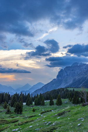 Stunning mountain landscape with colorful sky at dusk in Friuli Venezia Giuliaの写真素材