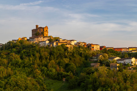 Sunset illuminating the village of Treville, located on a hill in the Piedmont region of Italy,...