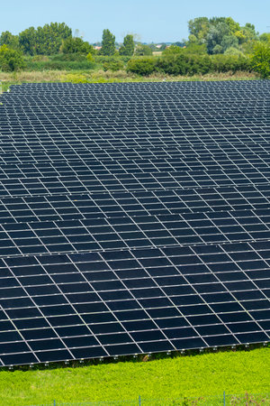Photovoltaic panels in a solar power plant converting solar energy into electricity in Loreo,...