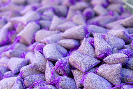 Small purple pouches filled with dried lavender create a fragrant and colorful display at a market in Nyons, Franceの写真素材