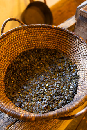Wicker basket overflowing with Styrian pumpkin seeds, showcasing a local delicacy in Heimschuh, Austriaの写真素材