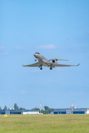 Modern private jet taking off from runway at Hostivice Airport near Prague in Czech Republic under...