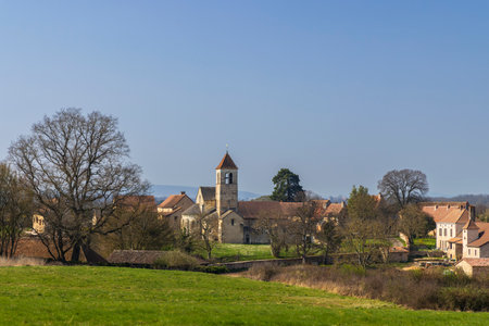 Scenic view of Chapaize village with its church and surrounding houses nestled amidst green meadows in Saone et Loire, Bourgogne Franche Comte, Franceの写真素材