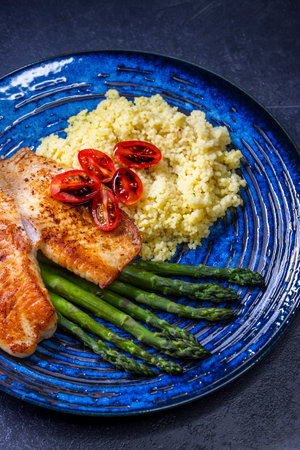 with asparagus and couscous and cherry tomatoes topped with a balsamic vinegar sauceの写真素材