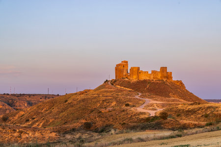 Historic castle overlooking Quicena during a serene sunsetの写真素材