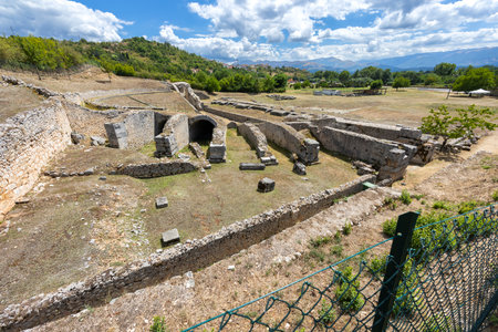 Ancient Roman ruins with stone walls and arches under a bright skyの写真素材
