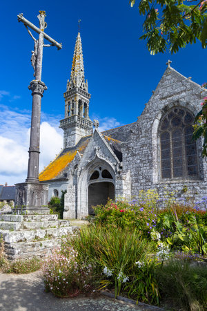 Saint Pol Aurelien church and calvaire with summer flowers under a blue sky in Finistere, Franceの写真素材