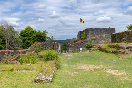 Ancient stone walls of Herbeumont castle ruins standing under a cloudy sky in Wallonia, Belgiumの写真素材