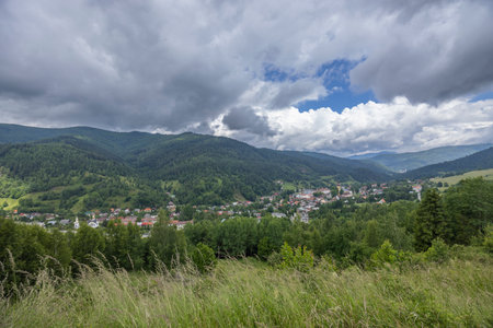 Smolnik village in Slovakia nestled in a forested valley surrounded by green mountainsの写真素材