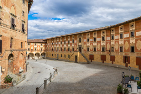 Historic buildings with ornate facades surrounding the quiet Piazza del Seminario in San Miniatoの写真素材
