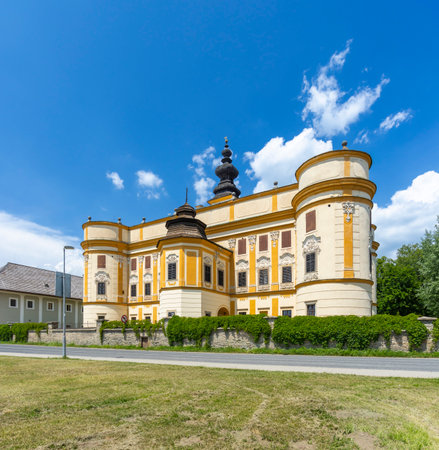 Historic Markusovce manor house facade with characteristic Baroque dome against a bright blue skyの写真素材