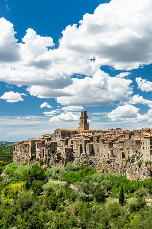 Ancient Pitigliano village built on a tufa cliff with historic buildings under a blue sky, Tuscanyの写真素材