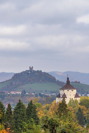 Defensive New Castle standing with Calvary Banska Stiavnica on a hill in autumnの写真素材