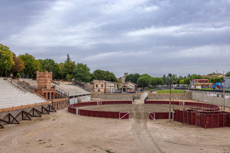 Empty bullring arena and stands under cloudy sky in historic Coca, Spain