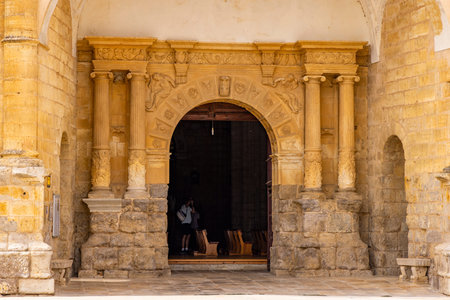 Intricate stone archway forming the entrance to an ancient church, inviting visitors insideの写真素材