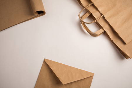products made from recycled kraft paper: packages, envelope and notebook. concept: environmental protection, recycling business. top view, copy spaceの写真素材
