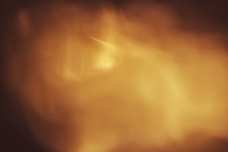 abstract background. Golden sparks and a cloud of dust.