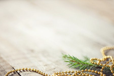 branches of spruce and beading on wooden background. new year card. copy spaceの写真素材