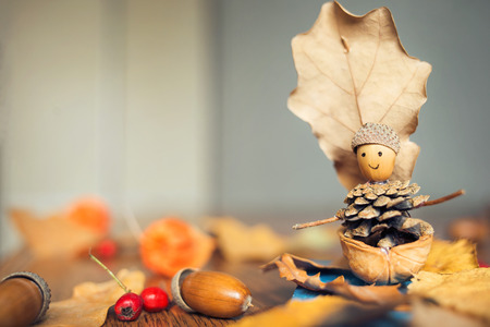 autumn craft with kids. childrens cute boat with man made of natural materialsの写真素材