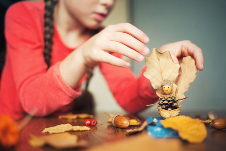 autumn craft with kids. childrens cute boat with man made of natural materials. process of creatingの写真素材