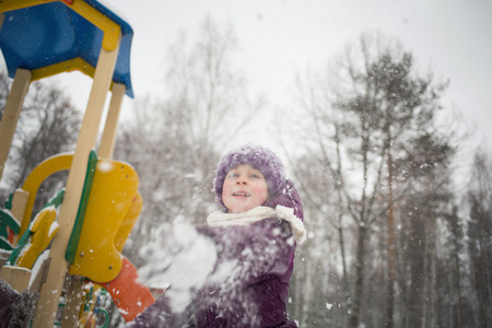 baby girl playing snowballs in winter Park. outdoor funの写真素材
