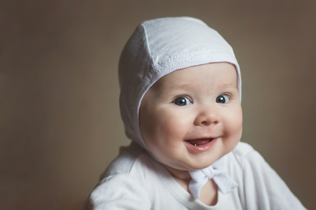 portrait of a baby in a white cap close-up. happy child.の写真素材