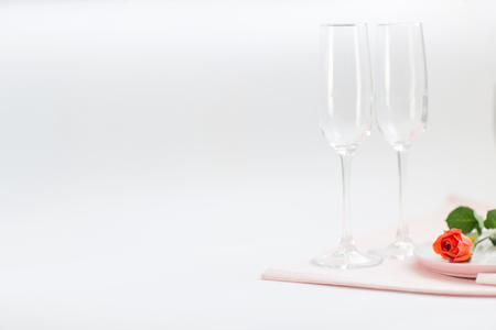 Dinner on Valentine's day. couple glasses and a rose on the table. copy space.の写真素材