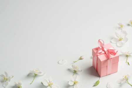 pink gift surrounded by Apple flowers. gentle background, copy space. present for mothers day, spring, Valentines day, womens dayの写真素材