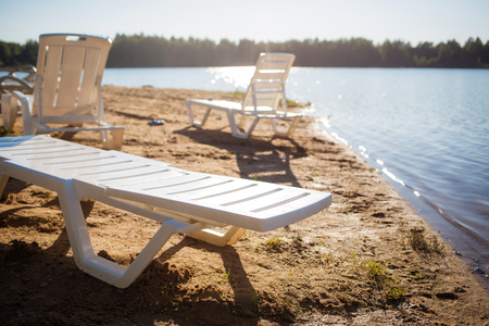 beach on the lake. empty deck chairs.の写真素材